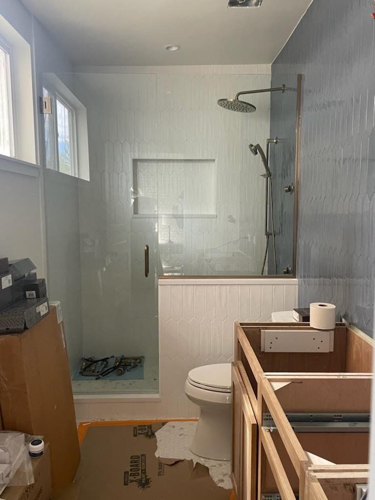 A bathroom under construction with a toilet , shower , and sink.