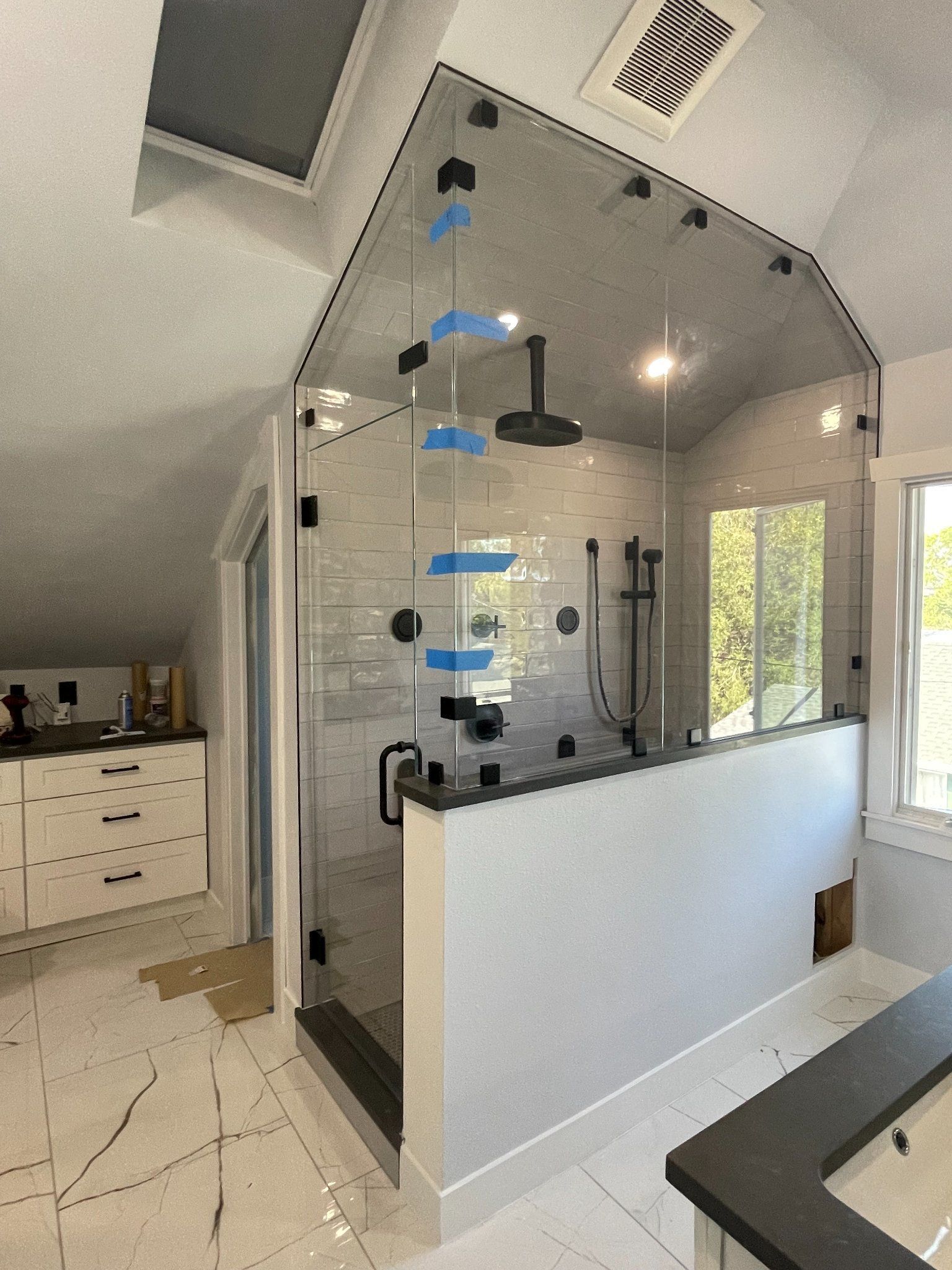 A bathroom with a walk in shower and a bathtub.
