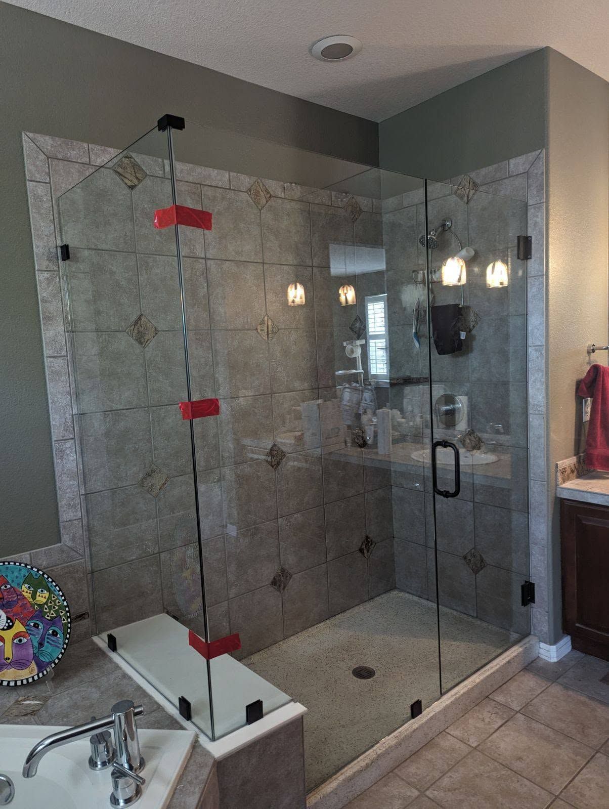 A bathroom with a walk in shower and a bathtub.