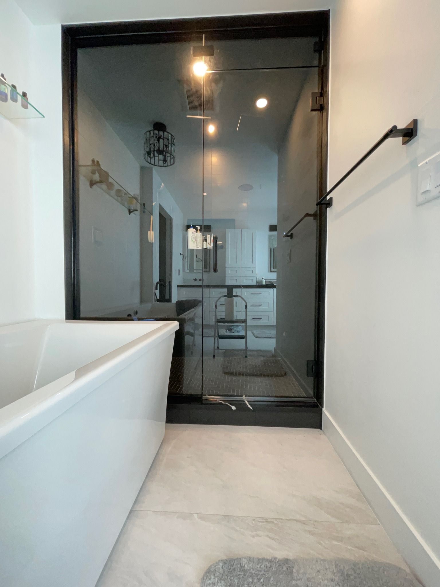 A bathroom with a bathtub and a glass door