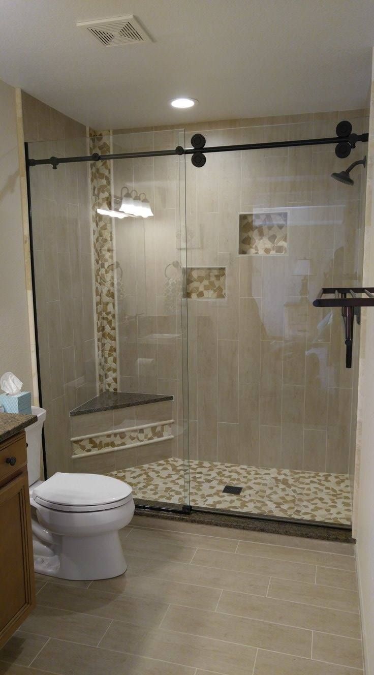 A bathroom with a toilet and a walk in shower.