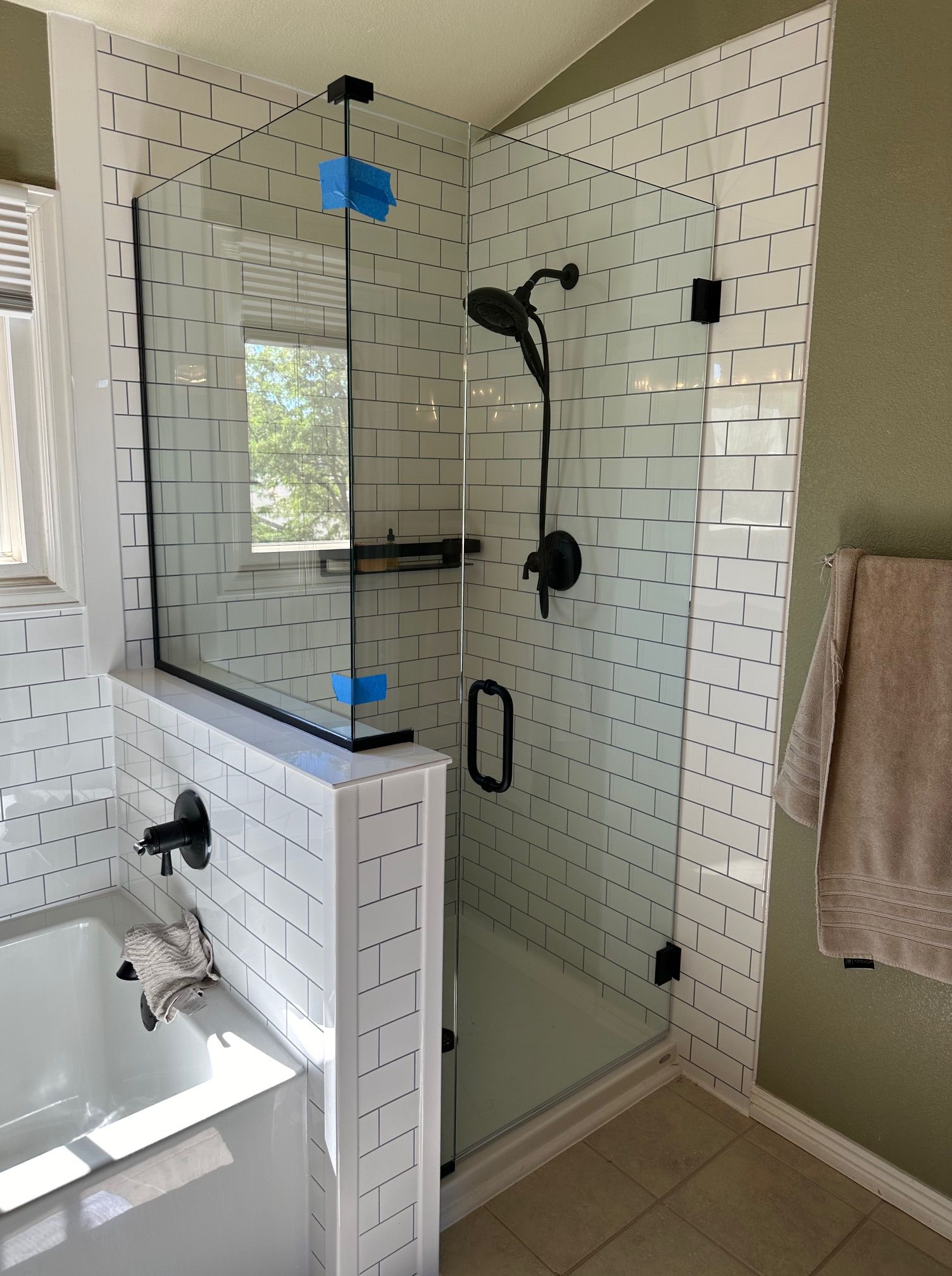 A bathroom with a walk in shower and a bathtub.