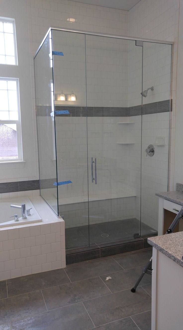 A bathroom with a walk in shower and a bathtub.