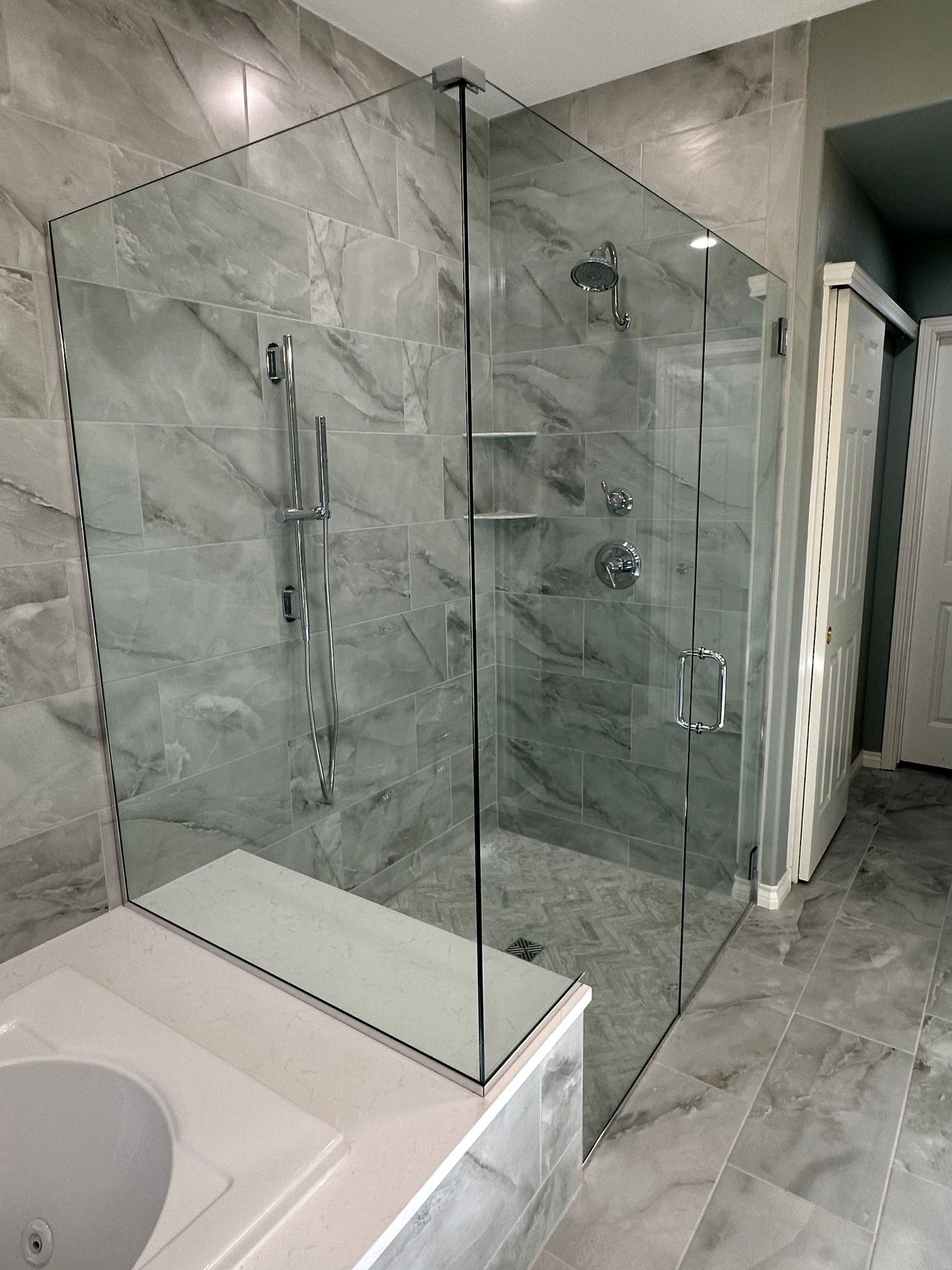 A bathroom with a walk in shower and a bathtub.