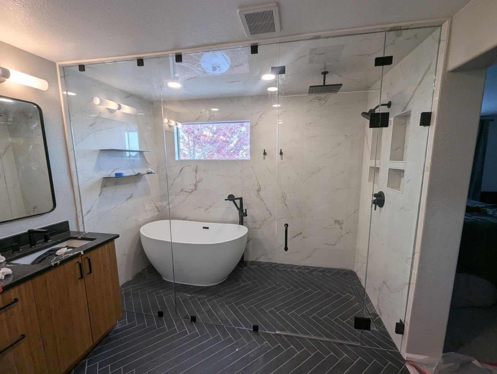 A bathroom with a bathtub and a walk in shower.