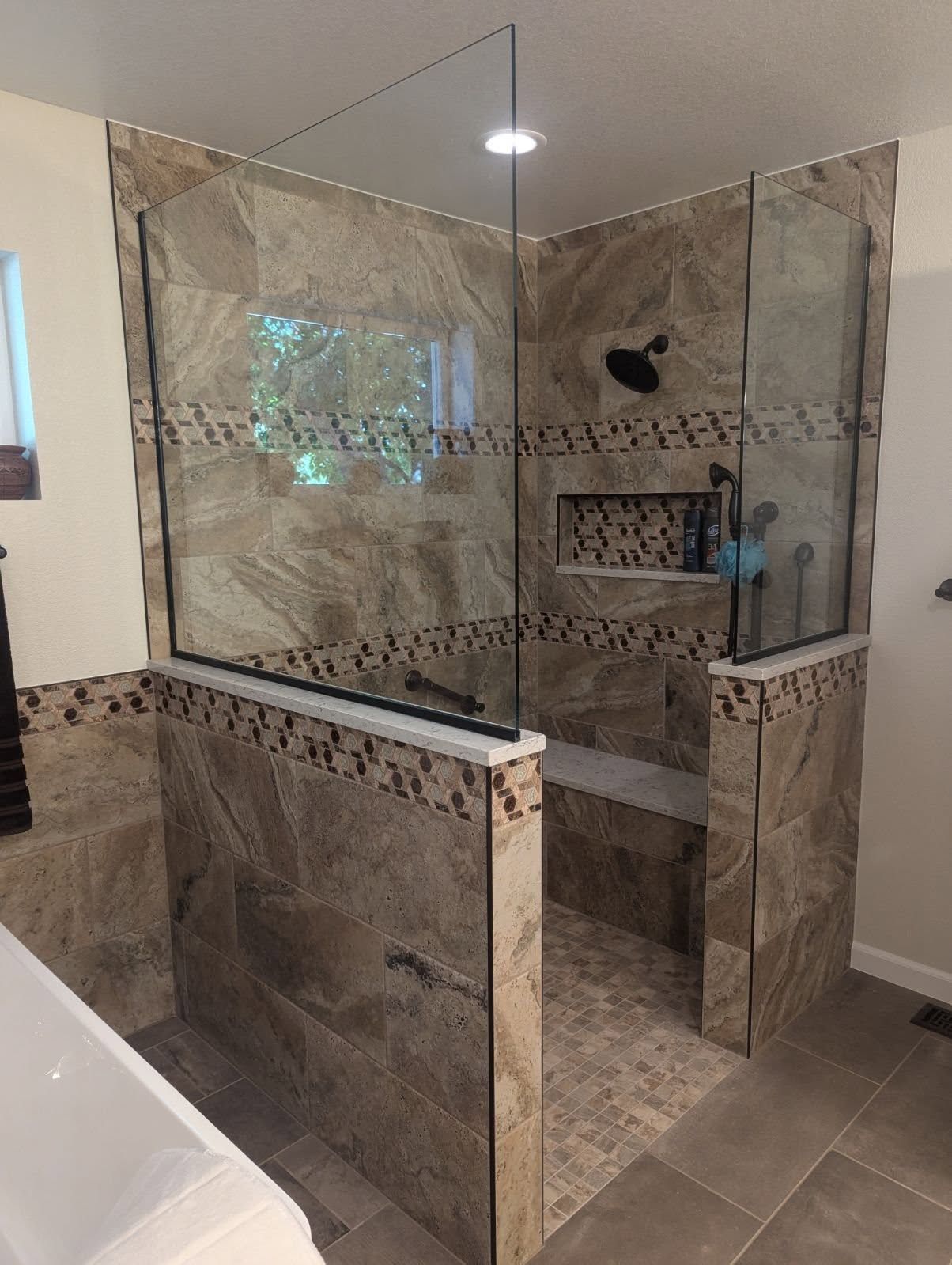 A bathroom with a walk in shower and a bathtub.