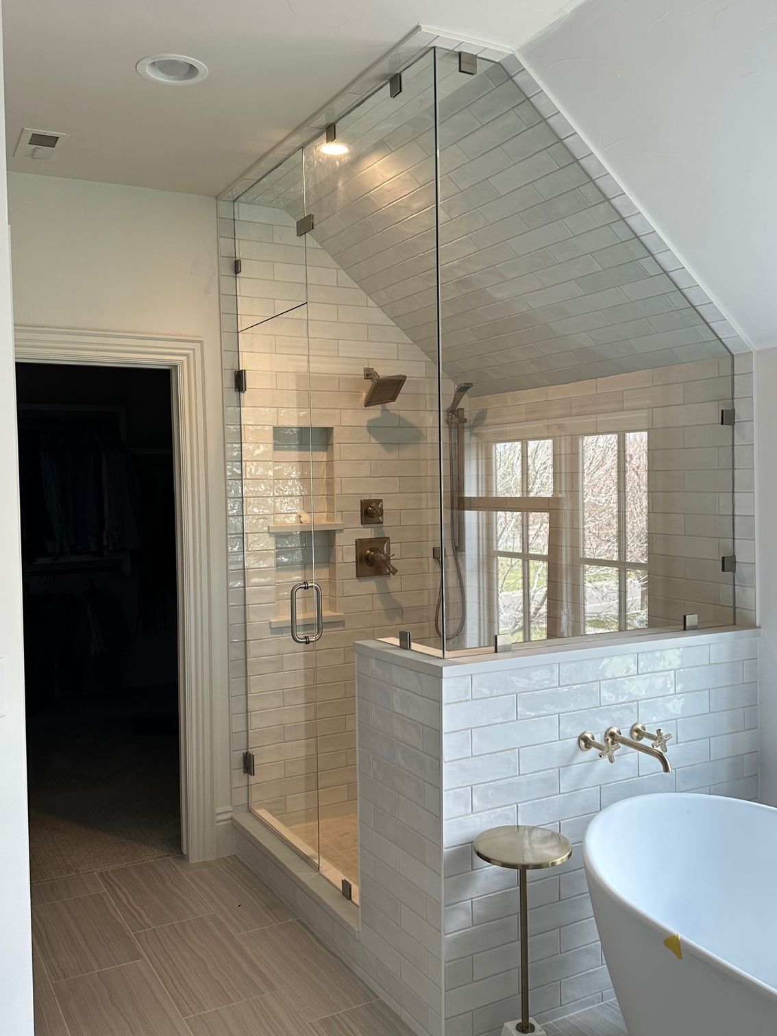 A bathroom with a walk in shower and a bathtub.
