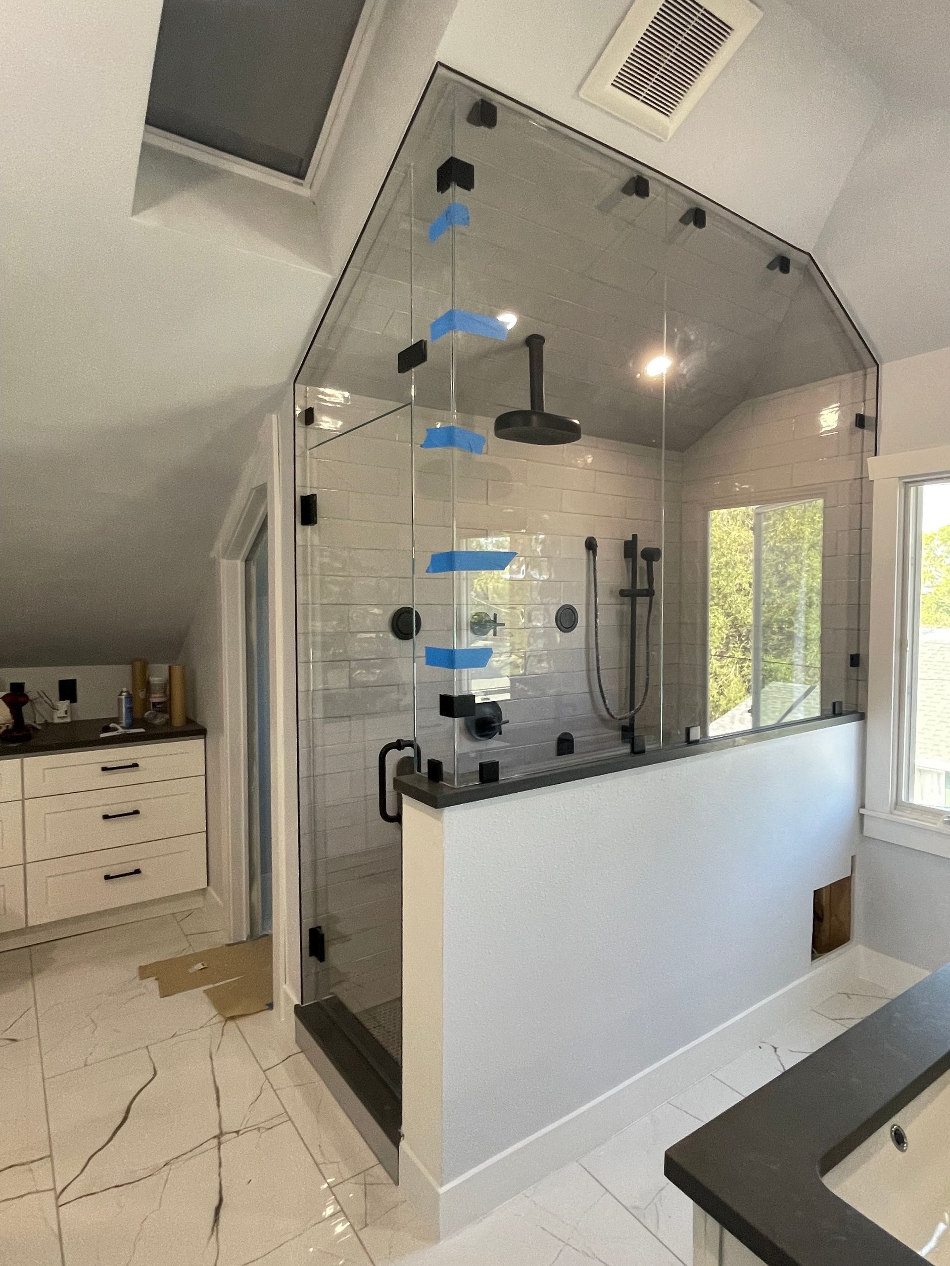 A bathroom with a walk in shower and a bathtub