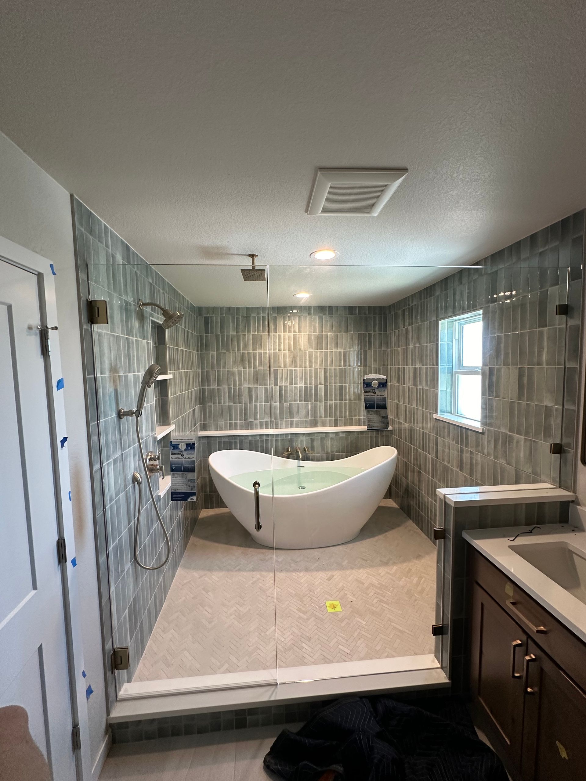 A bathroom with a bathtub and a shower.