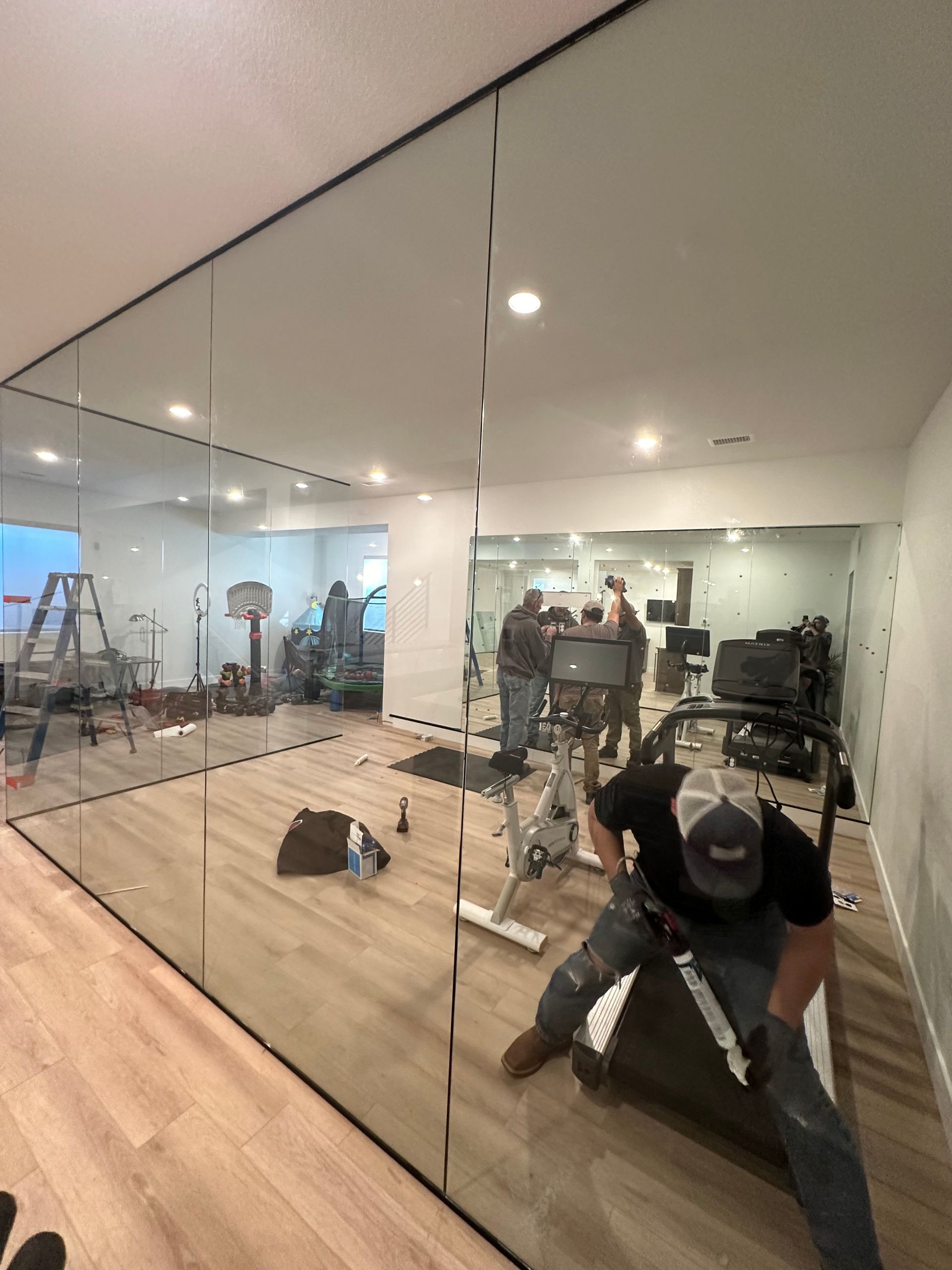A man is sitting on a treadmill in a gym.