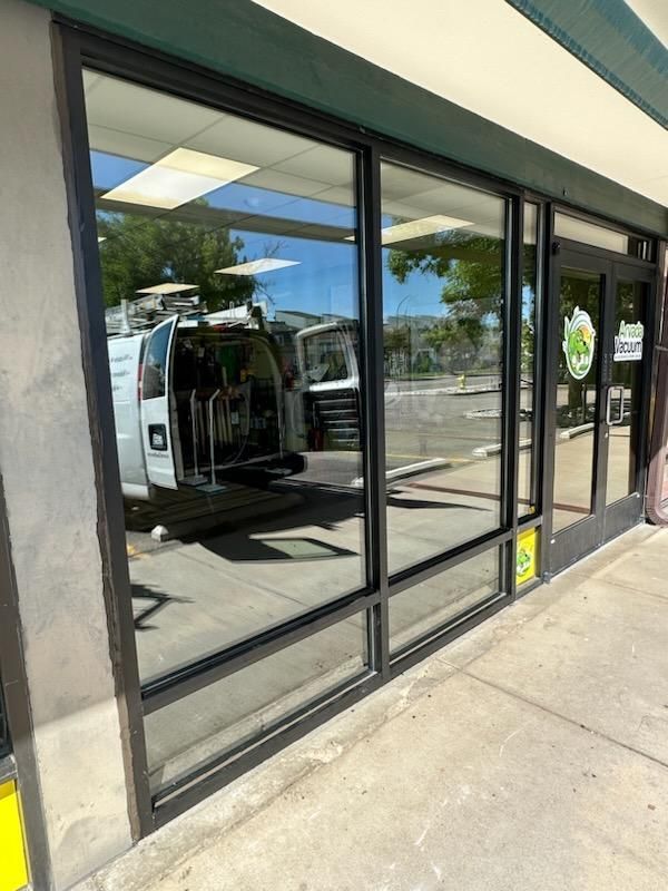 A van is parked in front of a building with a lot of windows.