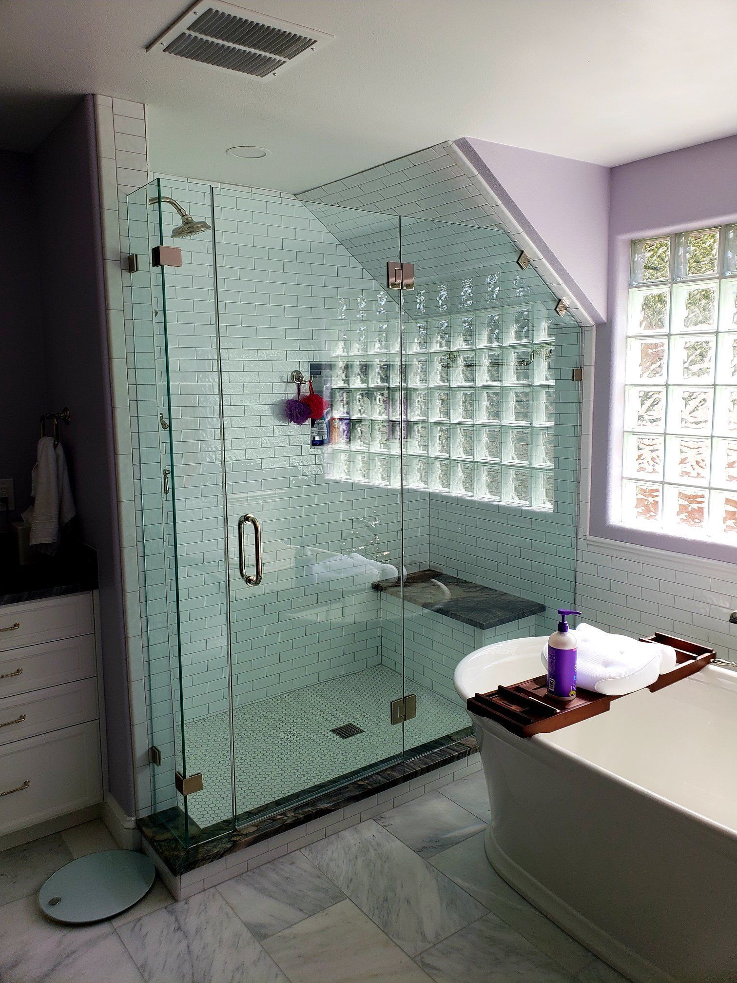 A bathroom with a walk in shower and a bathtub.
