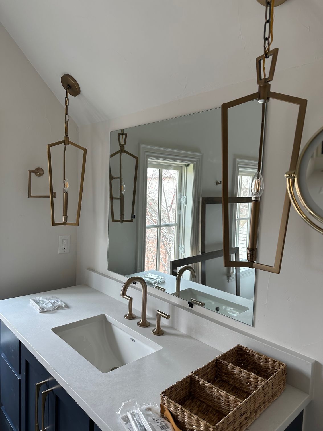 A bathroom with a sink and a large mirror.