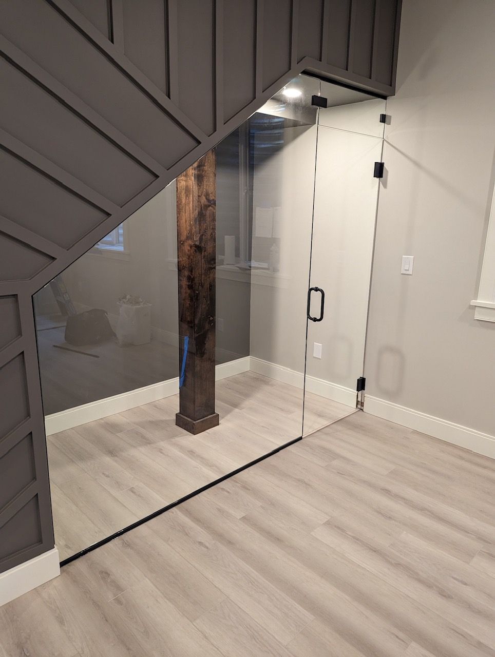 A room with a staircase and a glass door