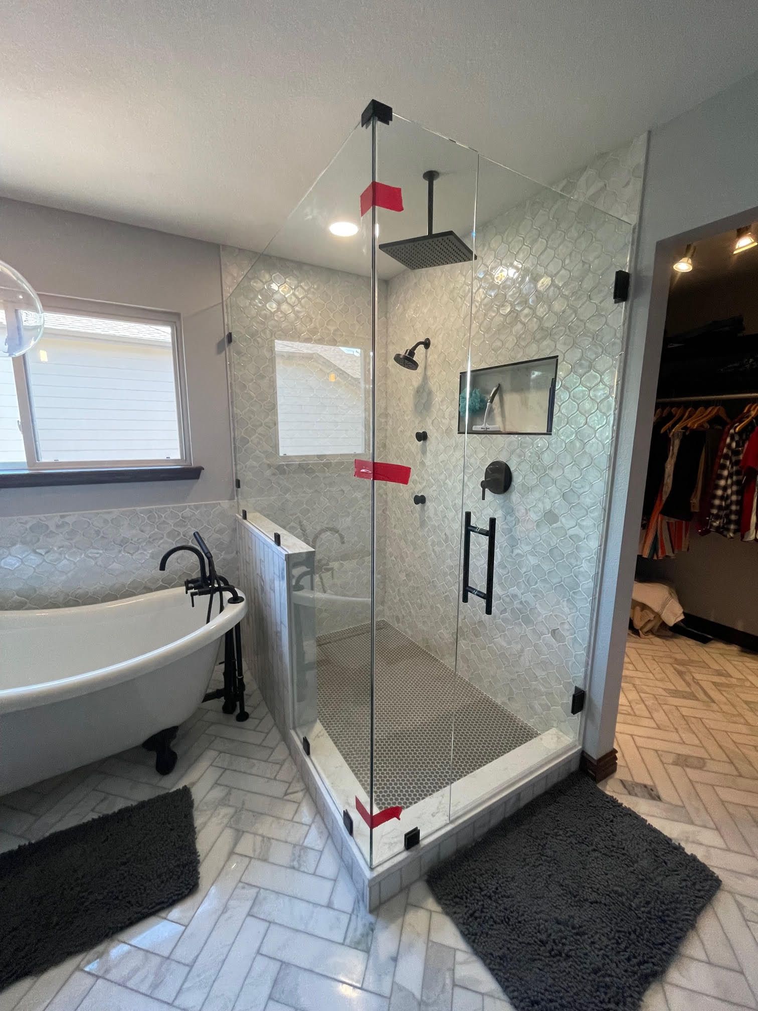A bathroom with a bathtub and a walk in shower.