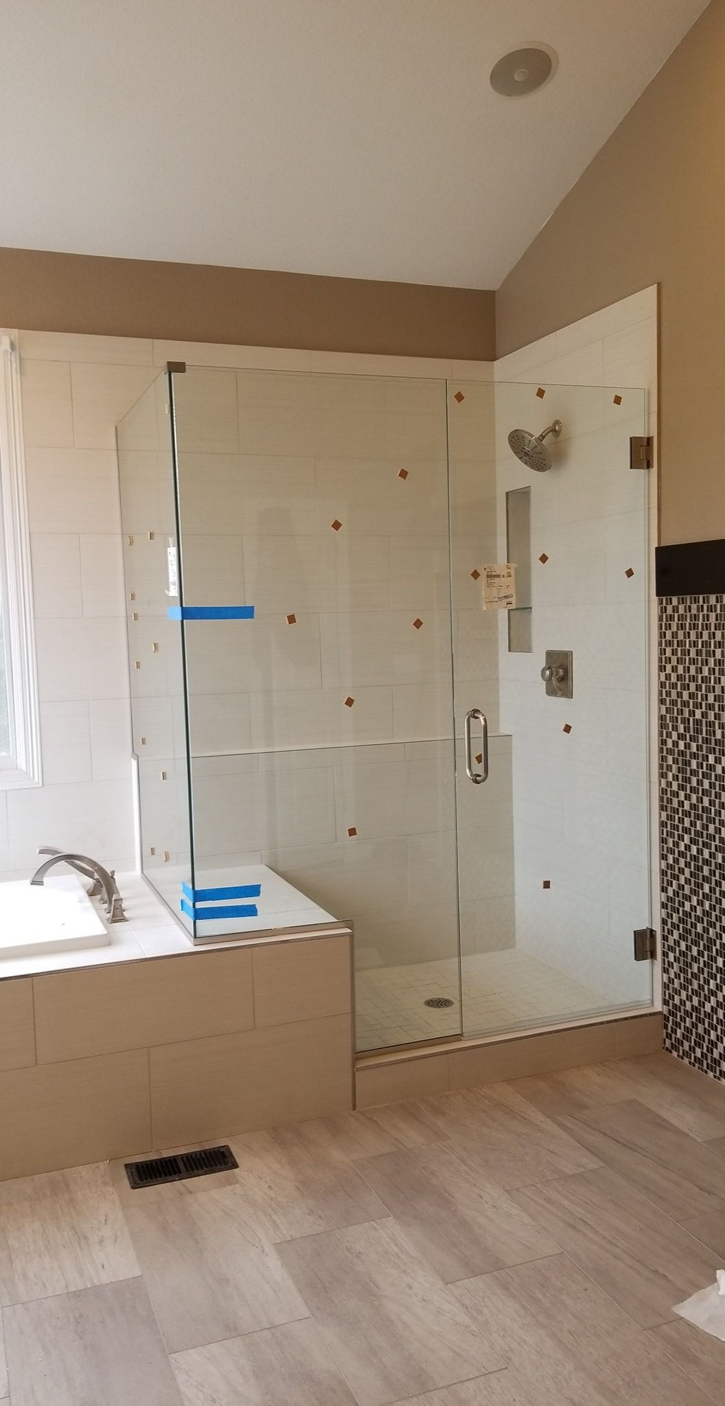 A bathroom with a walk in shower and a bathtub.