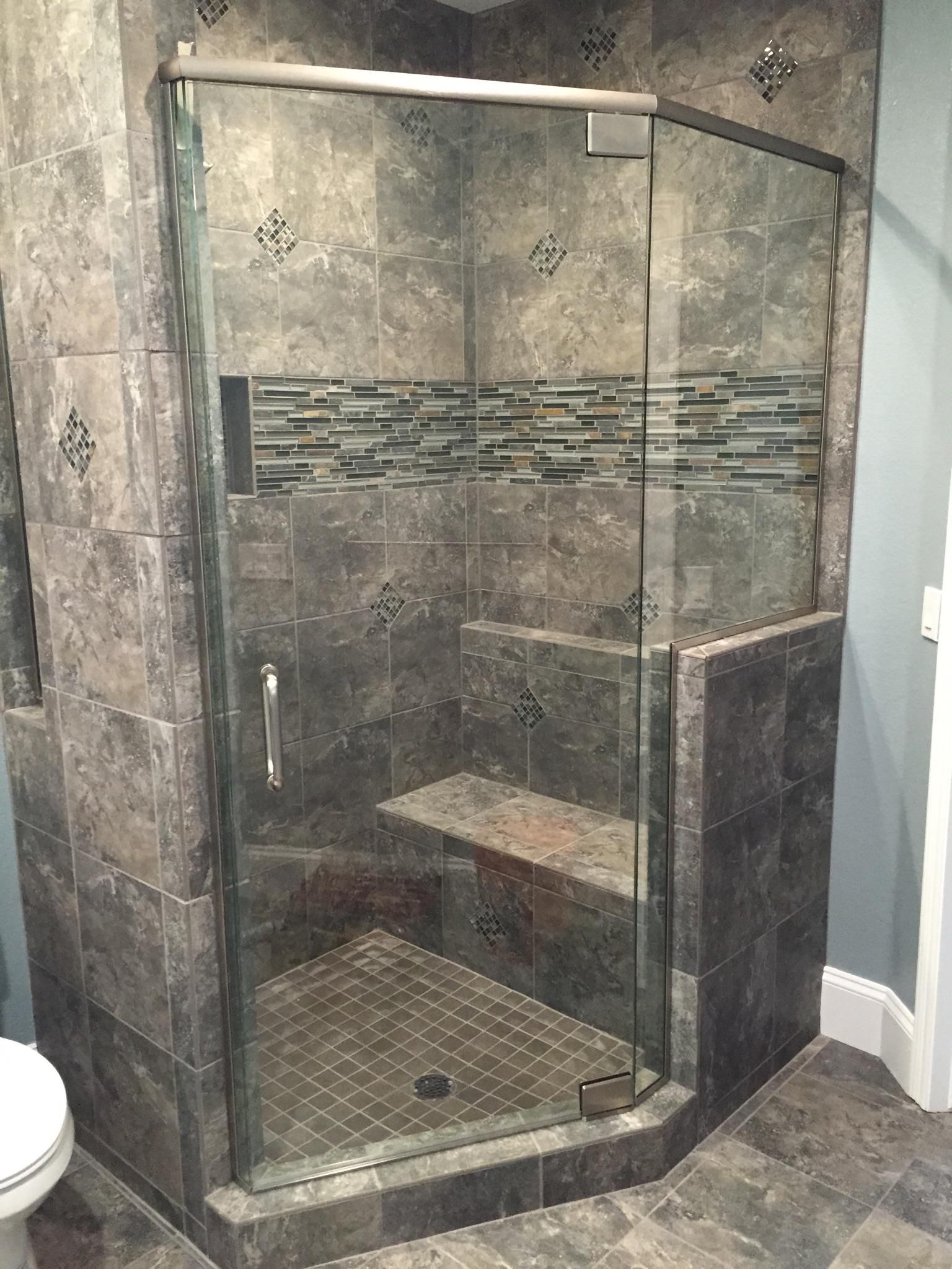 A bathroom with a walk in shower and a toilet.