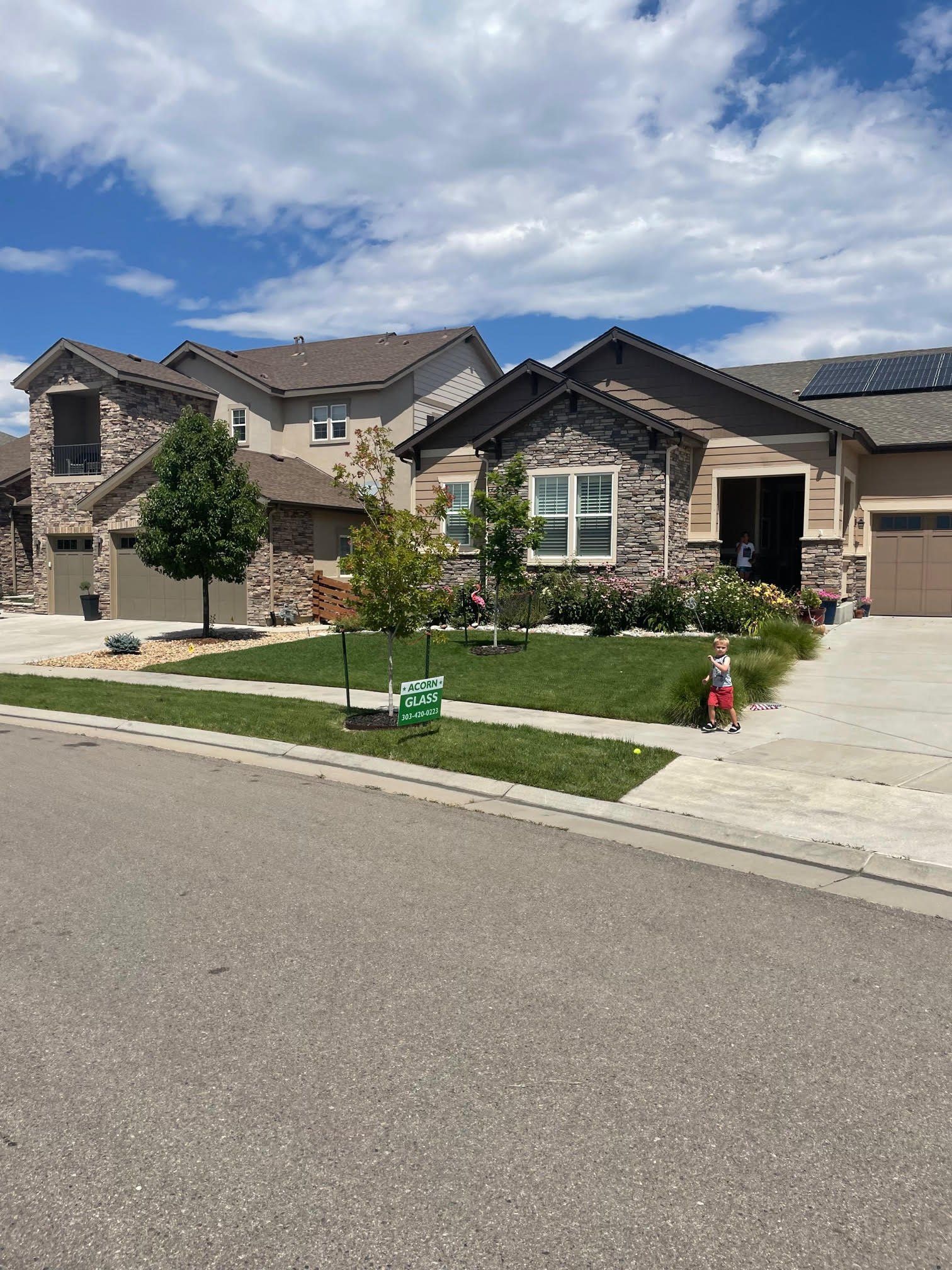 A large house with a lot of windows and a lawn in front of it.