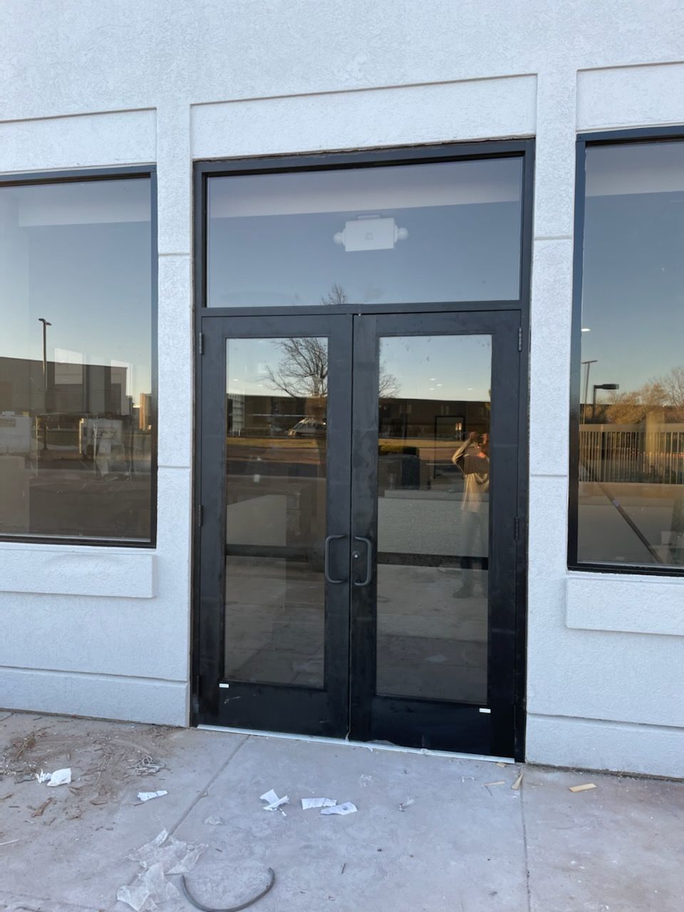 A white building with black doors and windows