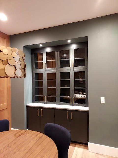 A dining room with a table and chairs and a window