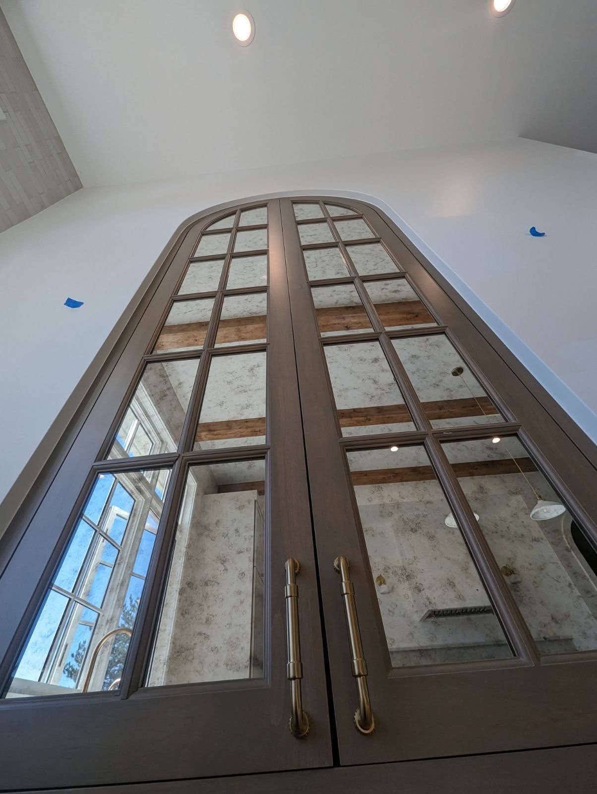 Looking up at a door with a reflection of a building in it