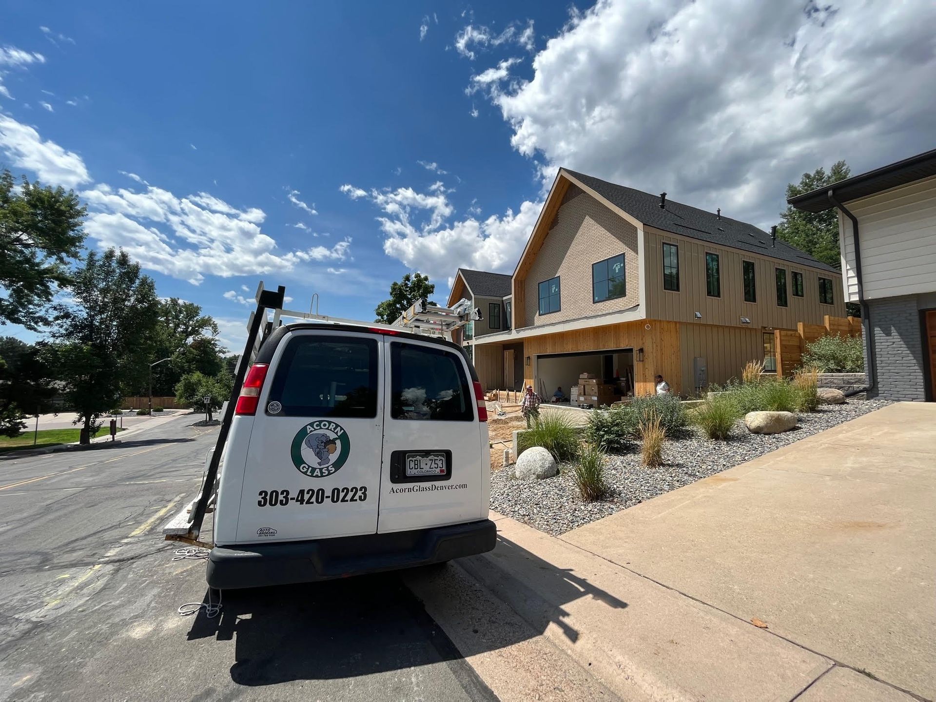 A white van is parked in front of a house.
