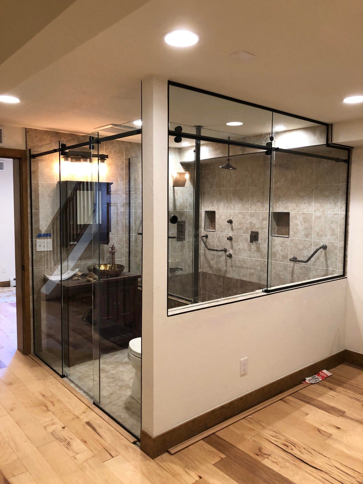 A bathroom with a sliding glass shower door and a toilet.
