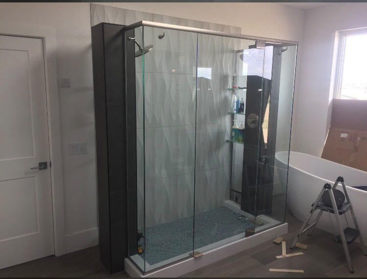 A bathroom with a walk in shower and a bathtub.