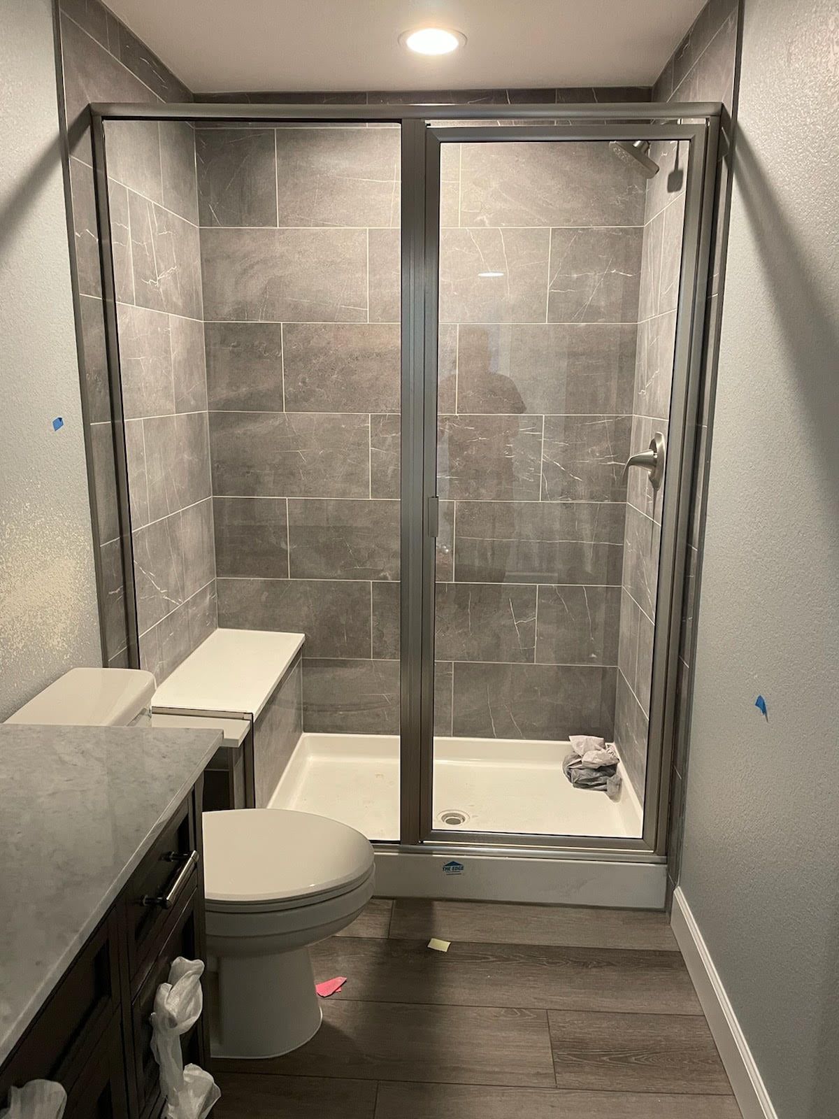 A bathroom with a toilet , shower and bathtub.