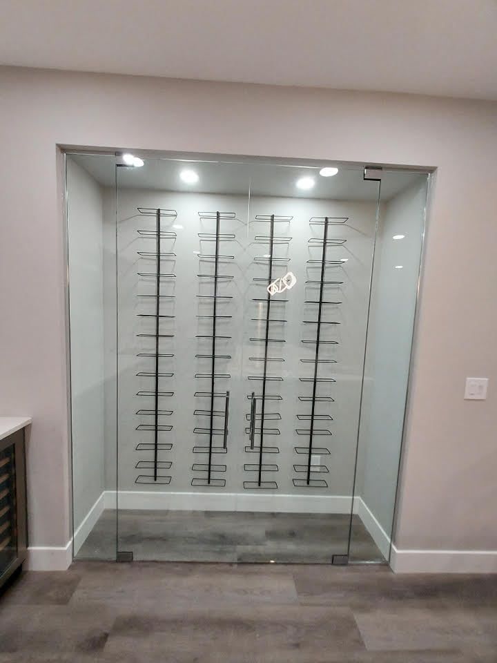 A glass door with a wine rack inside of it.