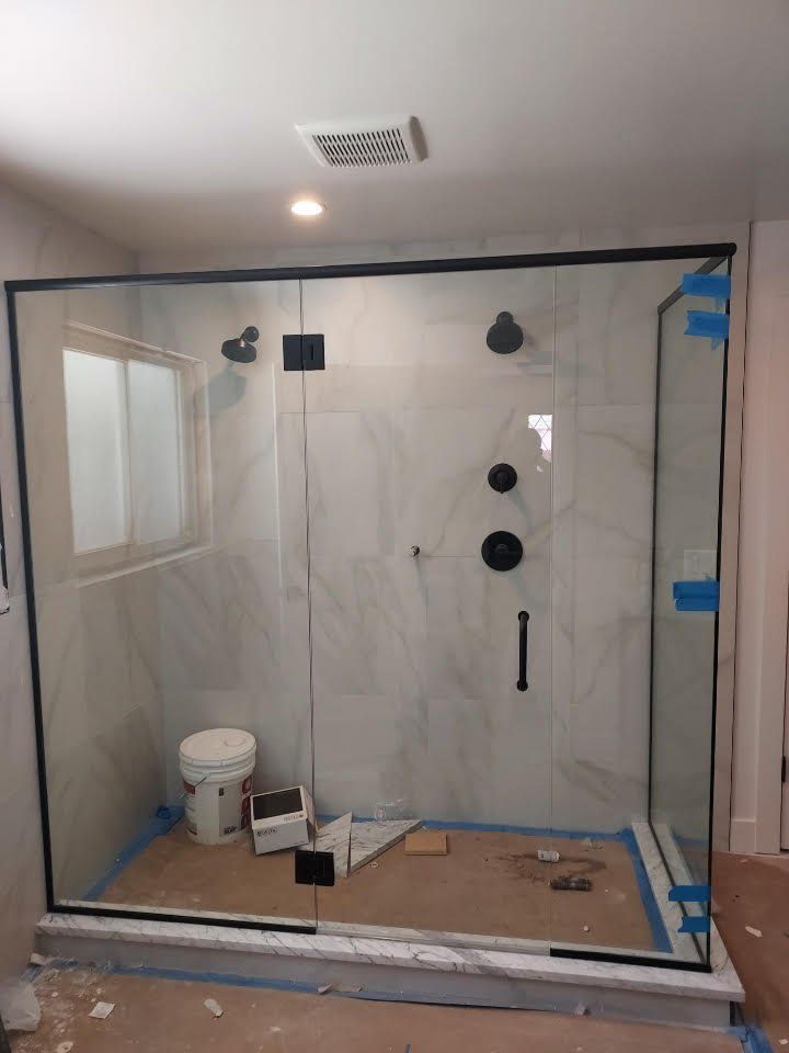 A bathroom with a toilet and a glass shower door