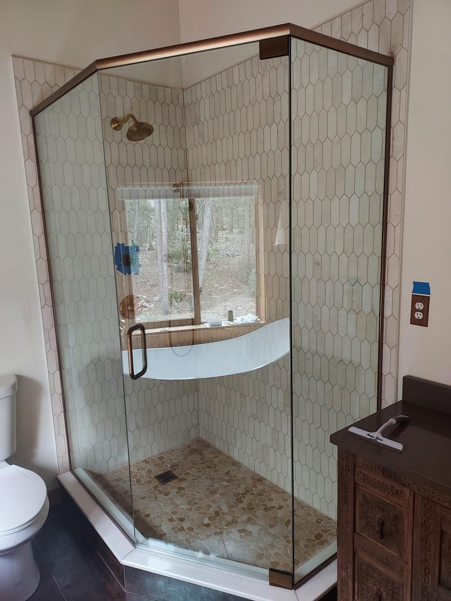 A bathroom with a walk in shower and a toilet.