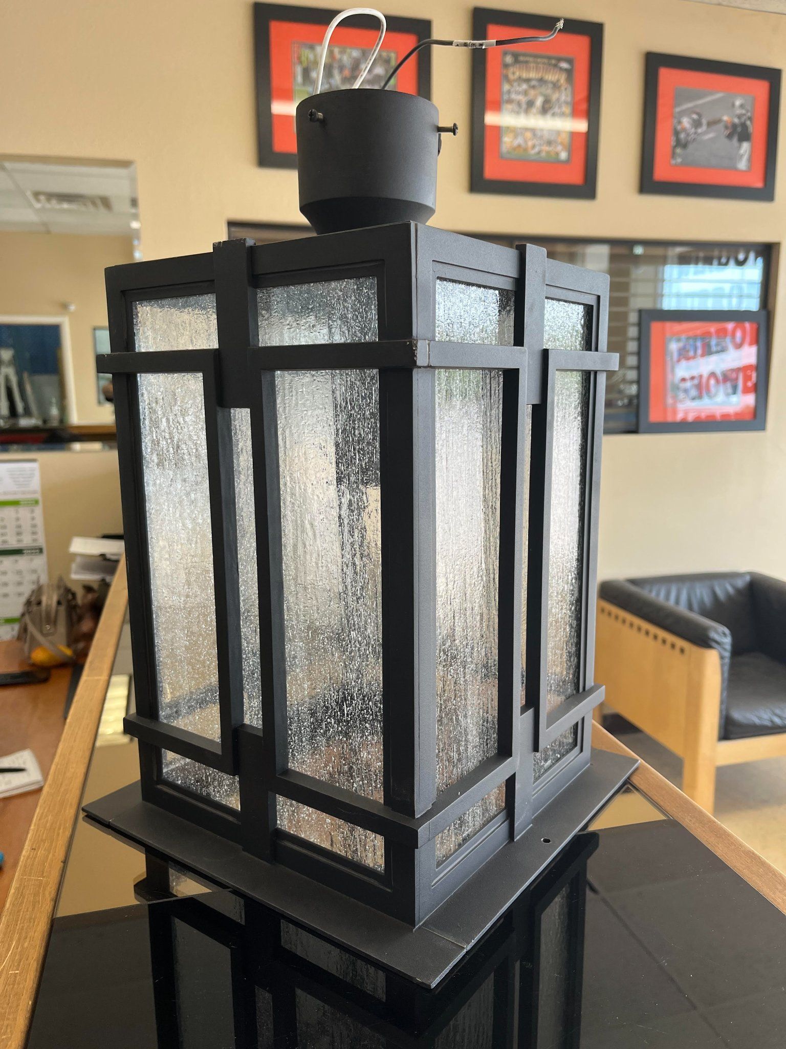 A black lantern is sitting on a table in a room