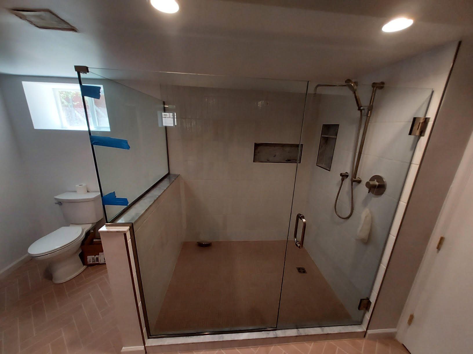 A bathroom with a walk in shower and a toilet