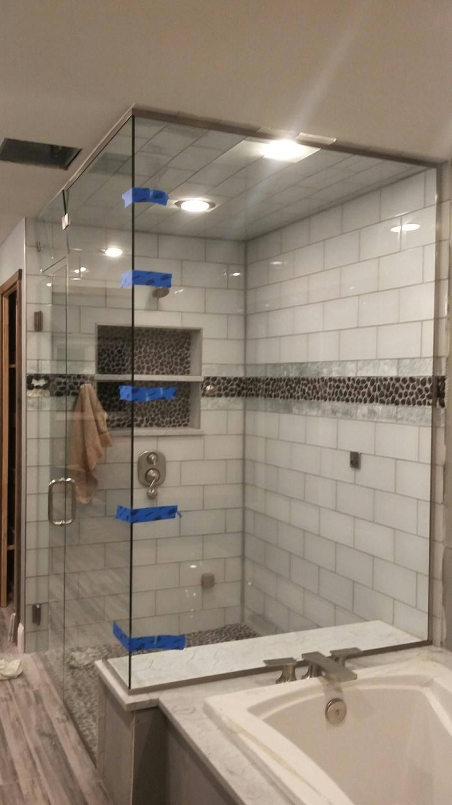 A bathroom with a walk in shower and a bathtub.