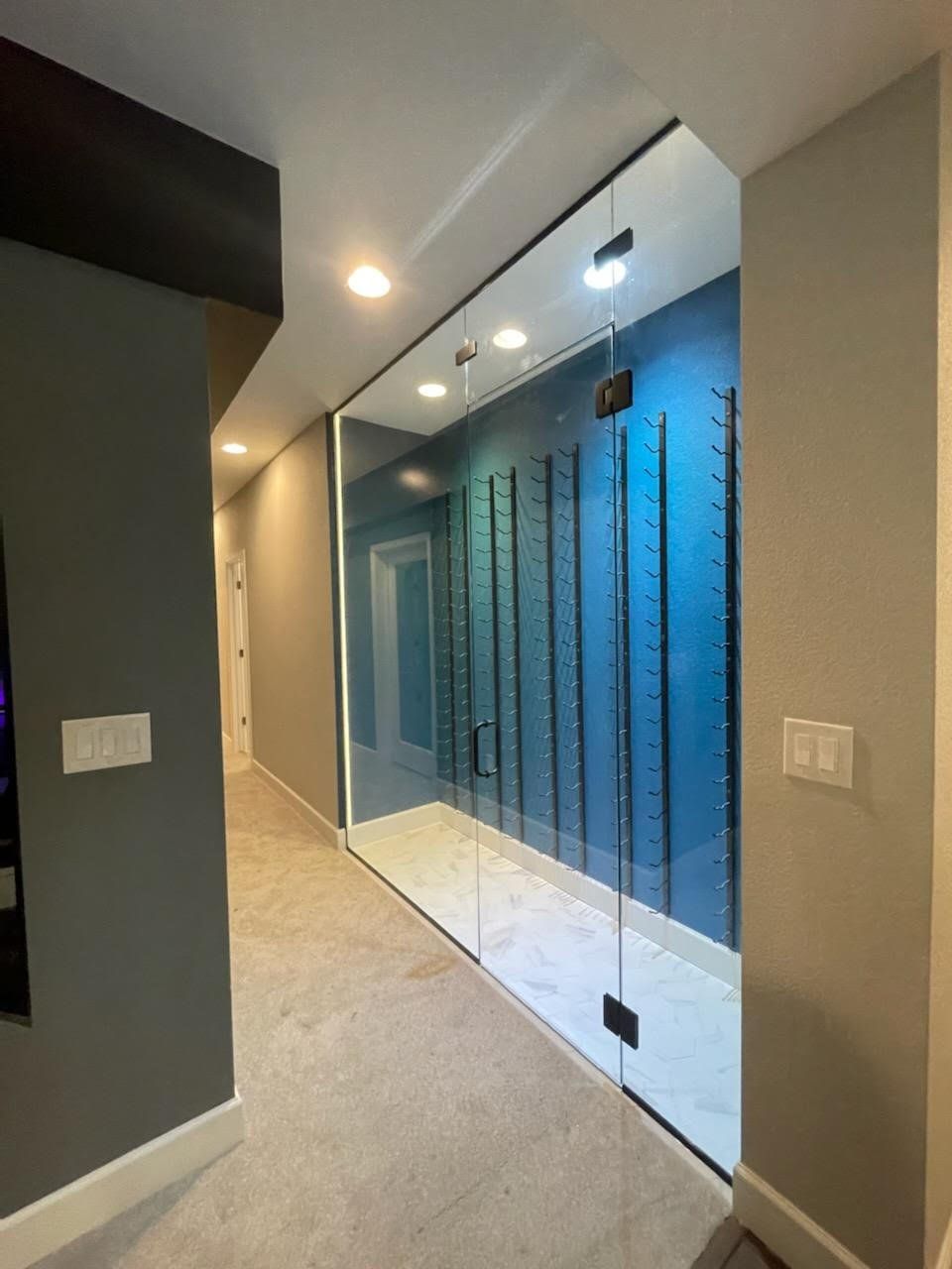 A hallway with a glass wall between two rooms