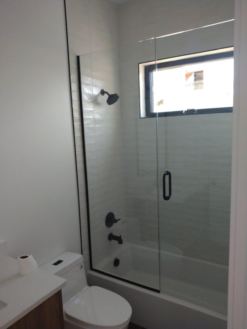 A bathroom with a toilet a sink and a shower