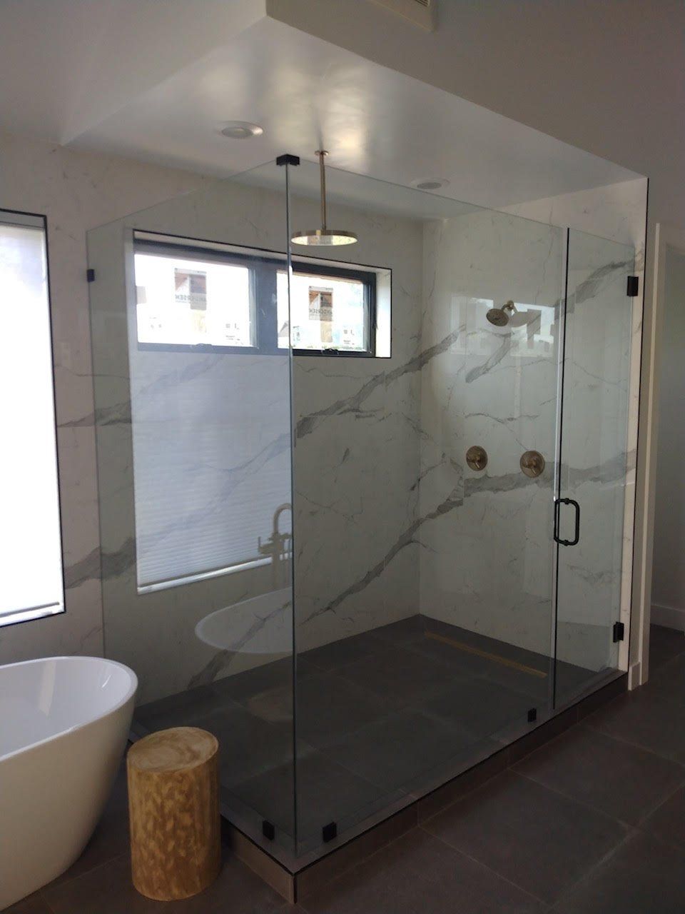 A bathroom with a walk in shower and a bathtub
