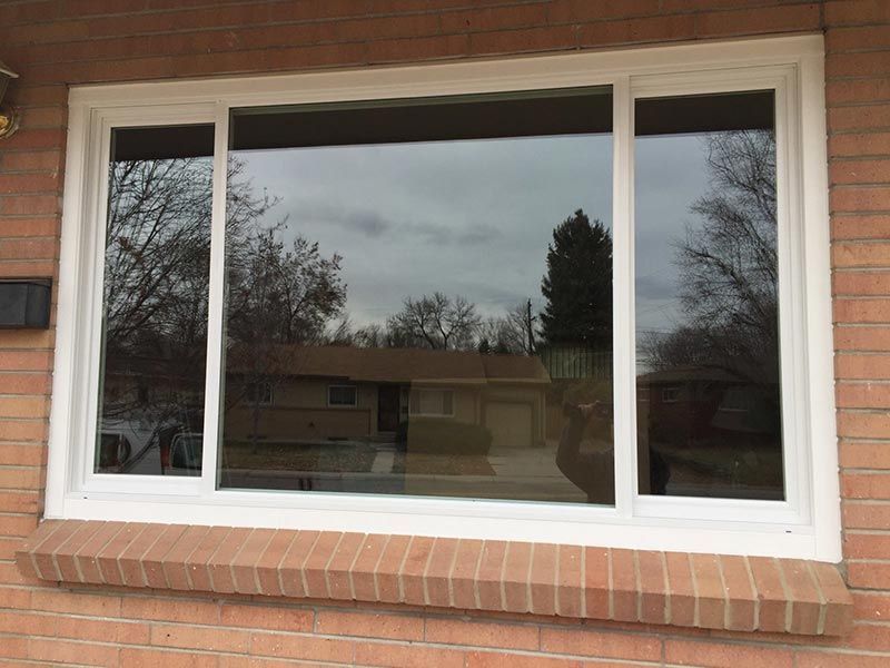 A large white window on a brick building
