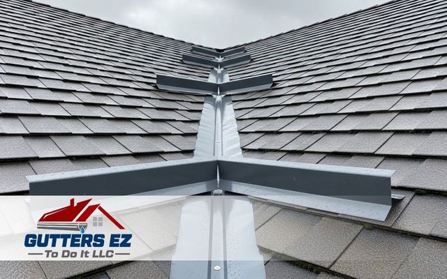 Roof valley with gray shingles and metal flashing, featuring Gutters EZ logo at bottom left