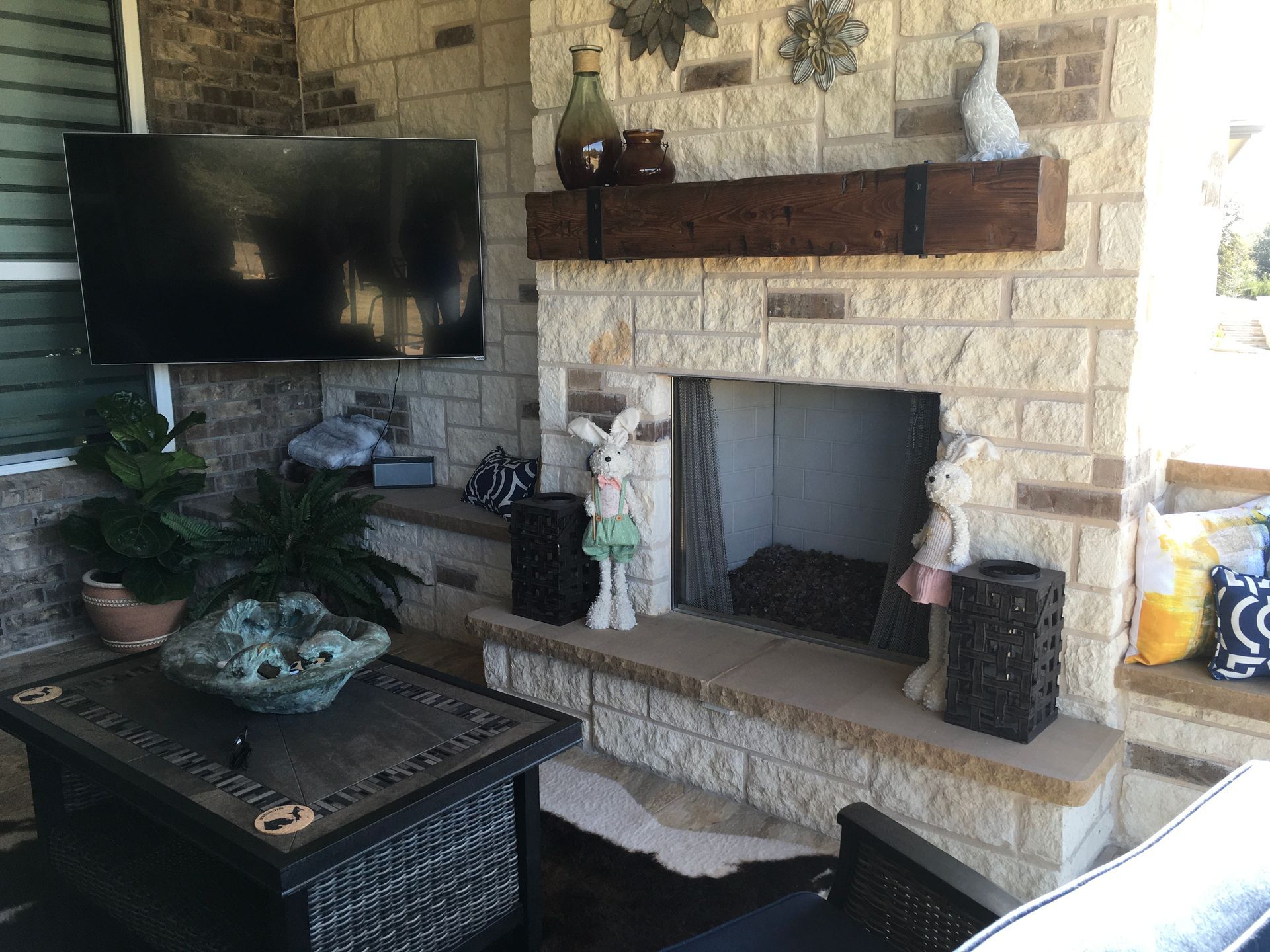 A living room with a fireplace and a flat screen tv