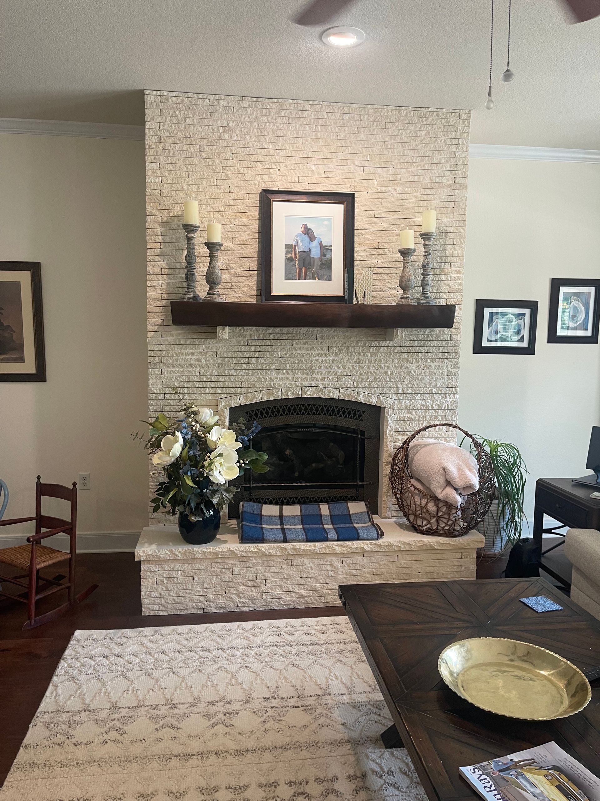 A living room with a fireplace and a rug