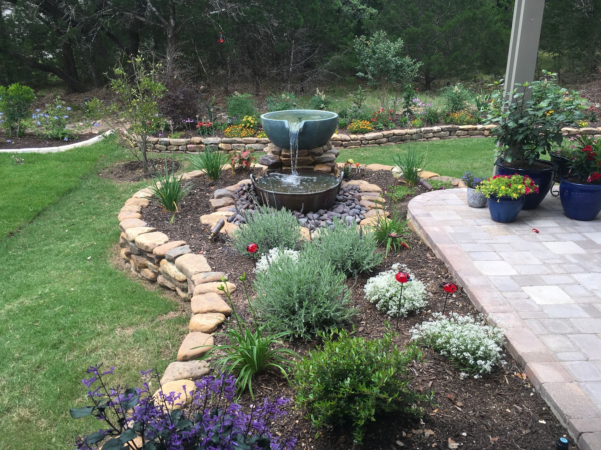 There is a fountain in the middle of the garden.
