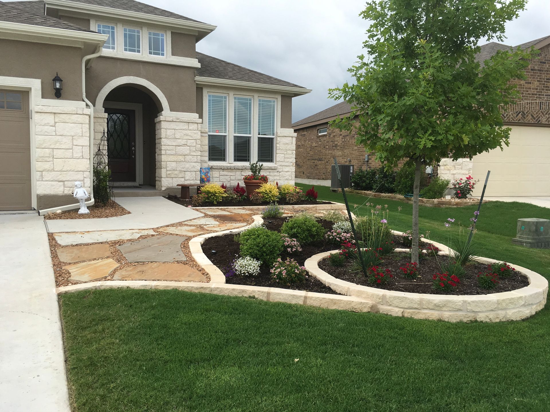 A house with a lush green lawn in front of it