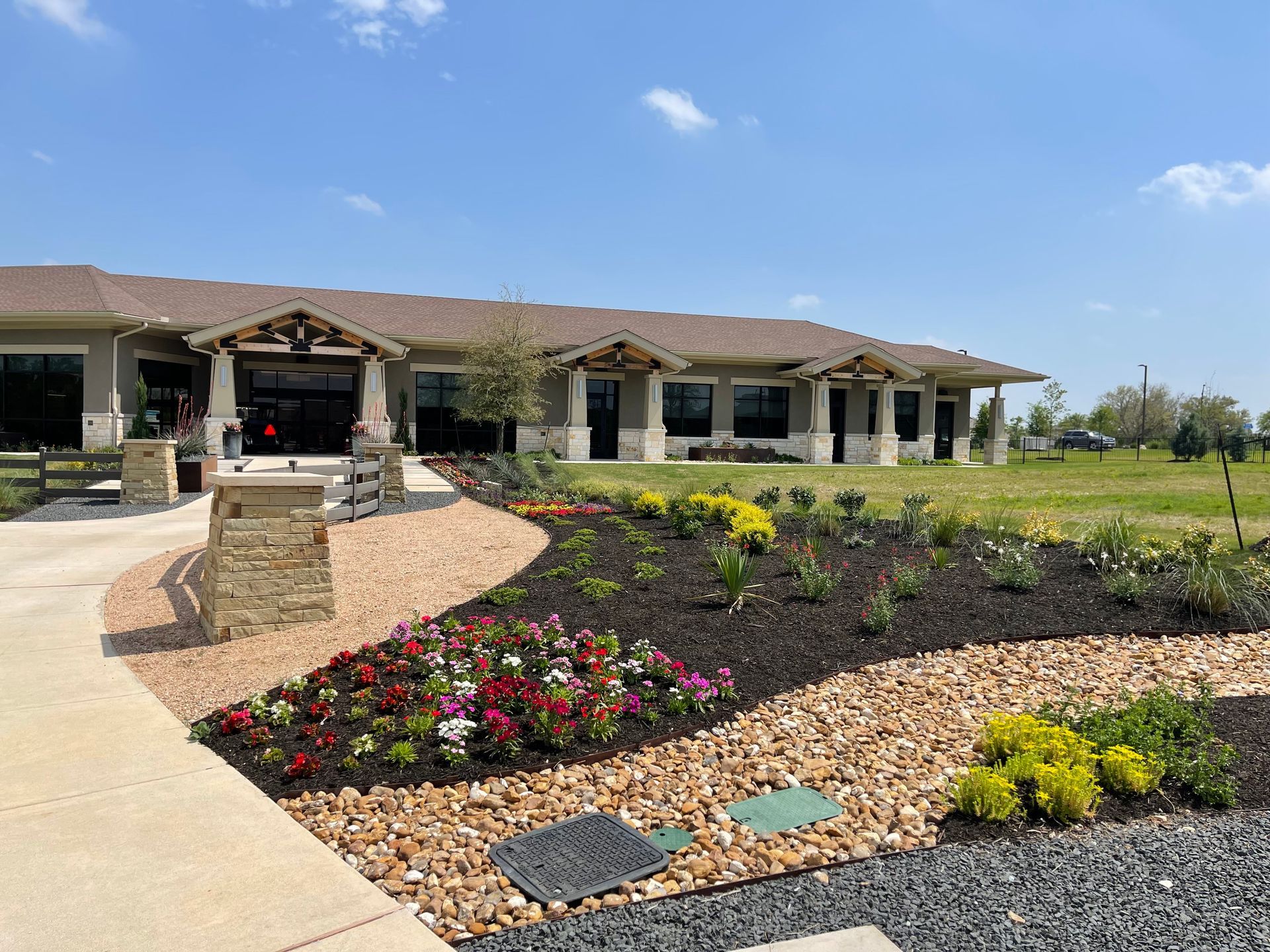 A large house with a lot of flowers in front of it.
