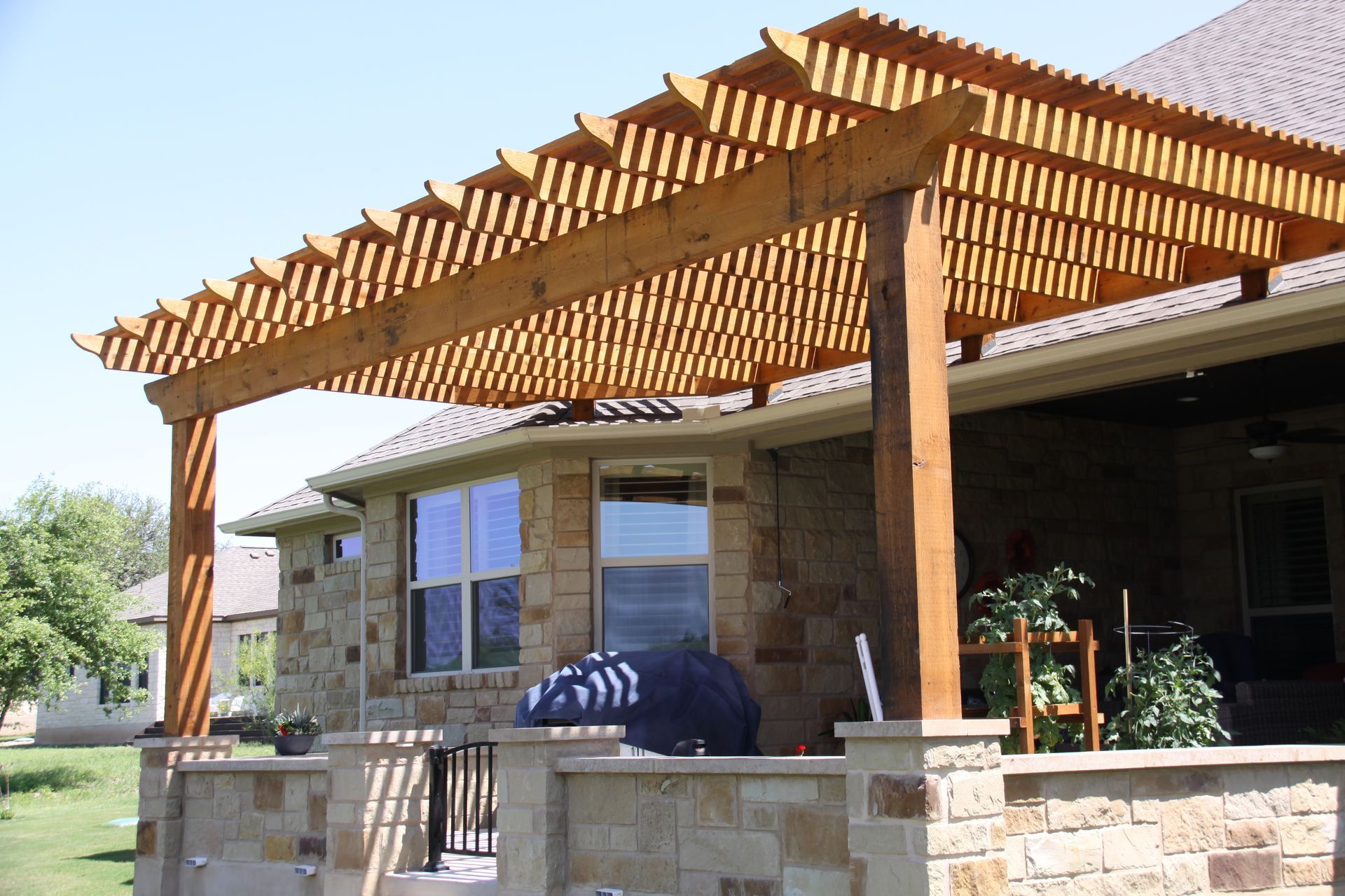 A house with a wooden pergola on top of it