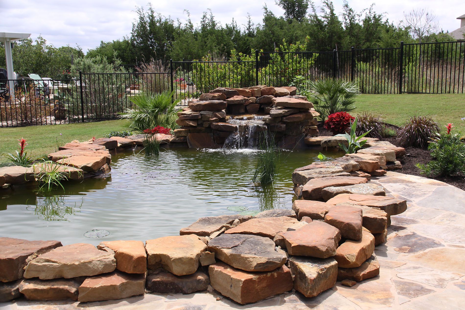 A pond with a waterfall in the middle of it