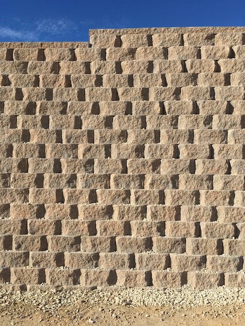 A brick wall with a blue sky in the background