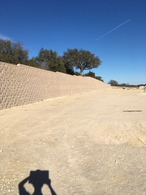 A shadow of a person taking a picture of a wall