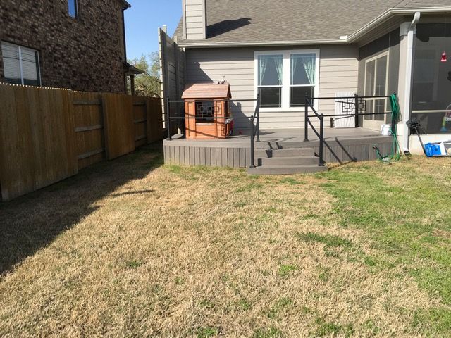 The backyard of a house with a deck and stairs